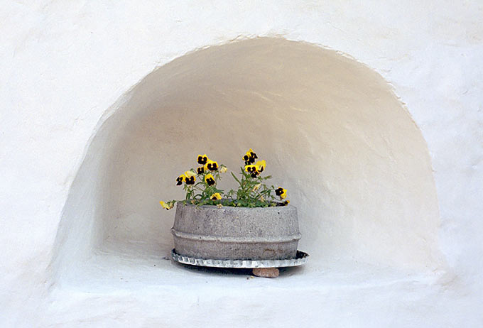 Loophole with flowers in Pechorsky Monastery